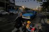 A woman crosses a street with a girl in downtown Tehran, Iran, Wednesday, July 22, 2026. (AP Photo/Vahid Salemi)