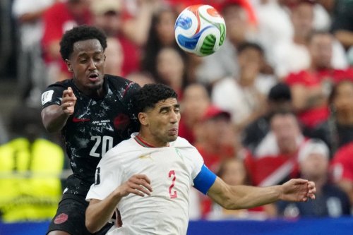 Canada's Ali Ahmed (20) and Morocco's Achraf Hakimi (2) vie for control of the ball during first half FIFA World Cup round of 16 soccer action, in Houston, Saturday, July 4, 2026. THE CANADIAN PRESS/Frank Gunn