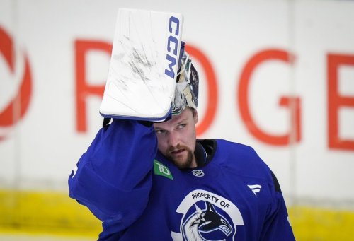 Vancouver Canucks goalie Thatcher Demko lifts his mask off his face while practicing with coaches during the opening day of the NHL hockey team's training camp, in Penticton, B.C., on September 19, 2024. THE CANADIAN PRESS/Darryl Dyck