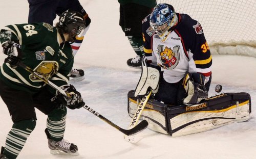 Knights forward Ryan Rupert watches Barrie Colts goaltender Mathias Niederberger deflects a shot wide in London, Ont., on May 13, 2013. THE CANADIAN PRESS/Dave Chidley