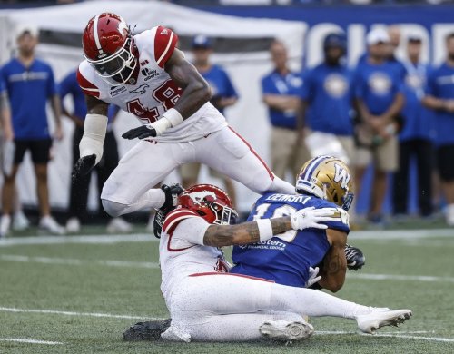 Winnipeg Blue Bombers' Nic Demski (10) gets tackled by Calgary Stampeders' R.J. Moten (48) and Damon Webb (9) during first half CFL football action in Winnipeg on Friday, July 24, 2026. THE CANADIAN PRESS/John Woods