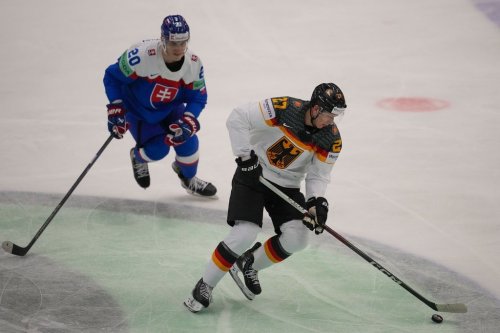 Germany's Maksymilian Szuber, right, challenges for a puck with Slovakia's Juraj Slafkovsky during the preliminary round match between Slovakia and Germany at the Ice Hockey World Championships in Ostrava, Czech Republic, Friday, May 10, 2024. The Montreal Canadiens signed Szuber to a one-year contract Aug. 3, 2026. (AP Photo/Darko Vojinovic)