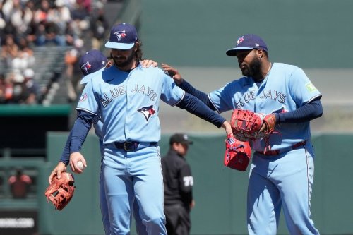 Toronto Blue Jays pitcher Dylan Cease, middle, reacts with shortstop Andrés Giménez, left, and first baseman Vladimir Guerrero Jr. after San Francisco Giants' Heliot Ramos hit a single during the ninth inning of a baseball game Wednesday, July 8, 2026, in San Francisco. (AP Photo/Jeff Chiu)