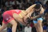 Kyrgyzstan's Aiaal Lazarev, in red, and Canada's Amar Dhesi compete in their men's freestyle 125kg repechage wrestling match at Champ-de-Mars Arena during the 2024 Summer Olympics, Saturday, Aug. 10, 2024, in Paris, France. (AP Photo/Eugene Hoshiko)