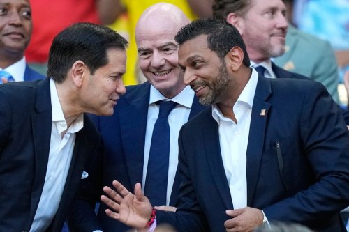 FIFA President Gianni Infantino, centre, stands with United States Secretary of State, Marco Rubio, left, and Director of the FBI, Kash Patel ahead of the World Cup Group K soccer match between Colombia and Portugal in Miami Gardens, Fla., Saturday, June 27, 2026. (AP Photo/Rebecca Blackwell)