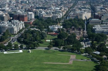 Construction continues on the helipad, center, and ballroom, right at White House, Friday, Aug. 7, 2026, in Washington. (AP Photo/Allison Robbert)