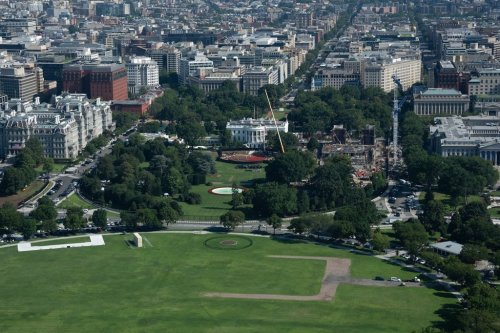 Construction continues on the helipad, center, and ballroom, right at White House, Friday, Aug. 7, 2026, in Washington. (AP Photo/Allison Robbert)