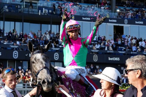 Jockey John Velazquez, atop Luster, throws flower petals in celebration of his win at the 167th running of the King's Plate horse race in Toronto, Saturday, Aug. 15, 2026. THE CANADIAN PRESS/Frank Gunn