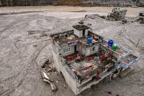 A drone view shows a damaged residential building along the swollen Trishuli River in the aftermath of flash floods in Nepal's Nuwakot district, Thursday, Sept. 3, 2026. (AP Photo/Rajesh Kumar Singh)