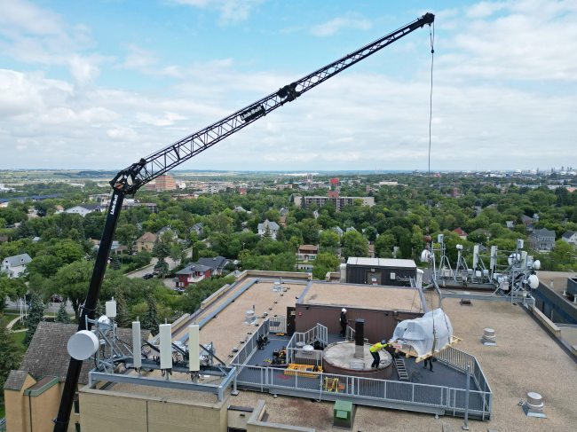 A crane is used to remove the old observatory dome for the Gulliver Astronomical Observatory from the roof of the McMaster Building at Brandon University and then to install the new dome on Tuesday. The old dome, installed in 1971, was replaced due to age and weathering. The new dome is weather-sealed and fully integrated with the telescope and automated so it can be operated remotely. The telescope was replaced in 2009. The Manitoba government provided $100,000 toward the dome replacement, alongside a $50,000 donation from the family of Brandon University astronomy Prof. Austin Gulliver. (Tim Smith/The Brandon Sun)