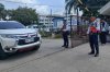 Security guards keep watch as vehicles exit the Ateneo de Zamboanga University following a shooting incident in Zamboanga, southern Philippines Tuesday, Aug. 18, 2026. (AP Photo)