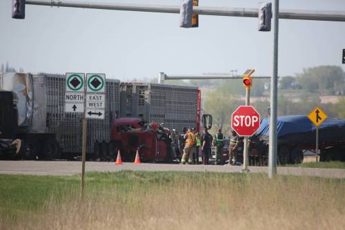 First responders stand at the scene of a fatal multi-vehicle crash involving a Conquer Transportation truck at the intersection of Highway 110 and Richmond Avenue East in Brandon on May 27. (Alex Lambert/The Brandon Sun files)