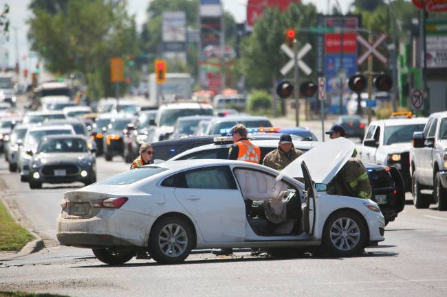 Traffic backs up in the northbound lane of 18th Street as emergency crews check the damage to one of two vehicles involved in a collision at the Park Avenue and 18th Street intersection on Friday during the noon hour. Airbags are clearly visible on the passenger side of the vehicle, though Brandon police indicated later Friday afternoon that there were no known injuries as a result of the collision. (Matt Goerzen/The Brandon Sun)