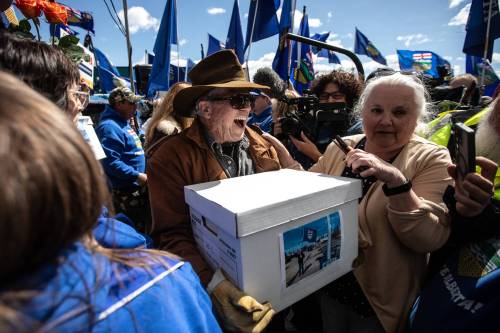 Supporters carry boxes of petition signatures to submit for a separation referendum to Elections Alberta in Edmonton last month. Columnist Constantin Colonescu calculates the fiscal ramifications of Alberta separation. 
                                (The Canadian Press)