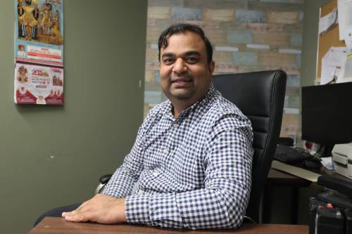 Brandon city council candidate Mitesh Patel, who is campaigning for a seat in Ward 10, sits for a photo at his office in downtown Brandon on Saturday. (Alex Lambert/The Brandon Sun)