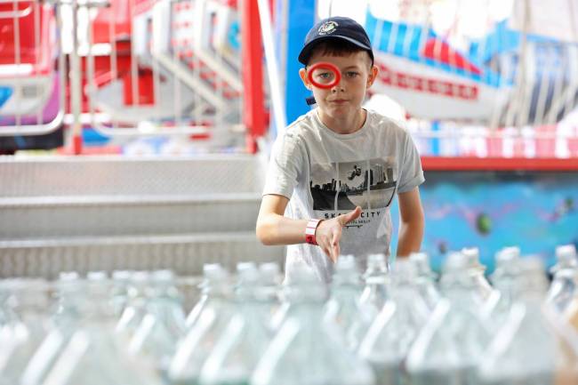 Weston Apperley tries his luck at the ring toss game during Midway Madness in the Canadian Tire parking lot in Brandon&rsquo;s south end on Wednesday afternoon. The four day fair began on Monday and ends today. (Tim Smith/The Brandon Sun)