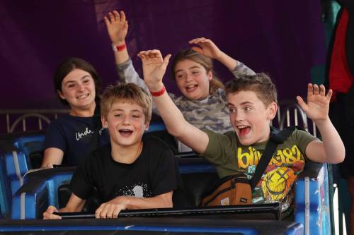 Owen Berry (front left), Noah Hammond (front right), Angelique Berry (back left) and Sophia Berry ride the Himalaya ride during Midway Madness.
