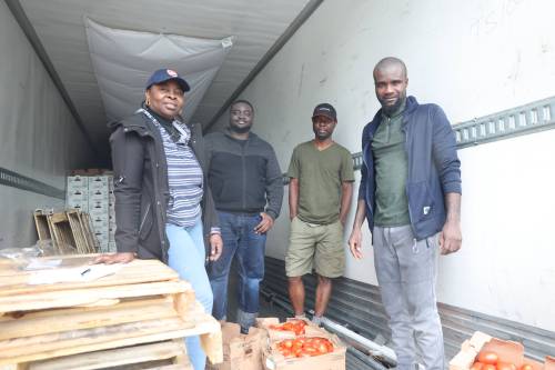Manaar Logistics owner Sanni Wasiu (right) and Akin Omole (second right) stand with other colleagues in the company&rsquo;s truck parked on Third Street on Friday morning. The truckload of about 2,000 boxes of Ontario-grown tomatoes arrived in Brandon earlier in the day. (Abiola Odutola/The Brandon Sun)