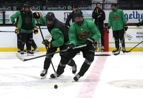 Bronsyn Mouille, right, battles 15-year-old forward Wyatt Lowther for the puck in a competition drill during a practice on Thursday during Brandon Wheat Kings training camp at Assiniboine Credit Union Place. The 17-year-old list player from Peace River, Alta., is looking to earn a spot. (Perry Bergson/The Brandon Sun)
                                Aug. 27, 2026