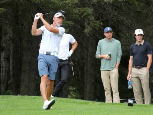 Jason Thorpe hits a tee shot while sons Ty, right, and Ryan watch during Tamarack golf tournament quarterfinals at Clear Lake Golf Course on Thursday. Thorpe beat defending champion Grady Chuback on the second playoff hole. (Thomas Friesen/The Brandon Sun)