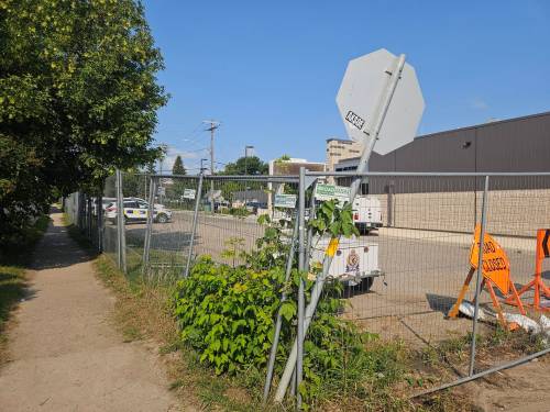Keren Grant wants the city to take down the fence at the back of the Brandon Police Service station. (Keren Grant)