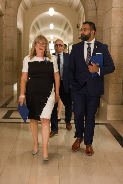 Colleen Robbins (left) walks alongside Progressive Conservative Leader Obby Khan in the Manitoba legislature in Winnipeg last September when Robbins was sworn in as the MLA for Spruce Woods. (Supplied)