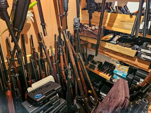 Some of the 445 firearms seized from 78-year-old Inky Mark's home in Dauphin in July. (Supplied)