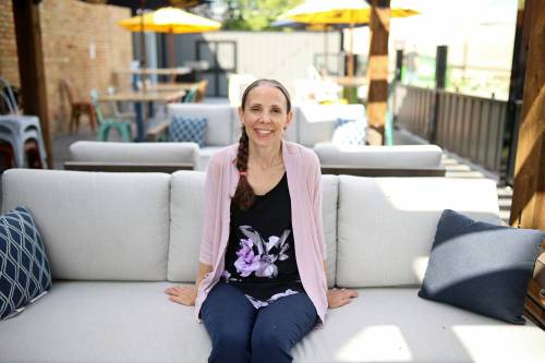 Erin Wells, manager of The Dock on Princess, sits on one of the couches in the pub and restaurant's new patio area on Friday. (Tim Smith/The Brandon Sun)