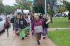 Elder Susie McPherson and a women's drum group lead a walk to mark International Toxic Drug Poisoning Awareness Day on Monday afternoon in Brandon. (Abiola Odutola/The Brandon Sun)