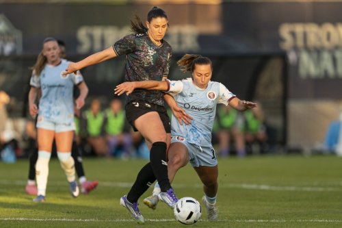 Vancouver Rise's Jessica De Filippo (left) battles with AFC Toronto's Sarah Stratigakis for the ball during the first half of an NSL soccer match, in Burnaby, B.C., on Friday, April 24, 2026. THE CANADIAN PRESS/Rich Lam
