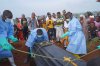 People dressed in protective gear lower into a grave the coffin containing the remains of Jeannine Katusabe, who died of Ebola, during a burial service in Bunia, Ituri province, eastern Congo, Tuesday, Aug. 11, 2026. (AP Photo/Dieudonne Dirole)