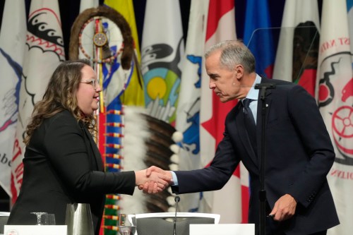 Prime Minister Mark Carney shakes hands with AFN National Chief Cindy Woodhouse Nepinak following his speech at the Assembly of First Nations Special Chiefs Assembly, in Ottawa in December 2025. (The Canadian Press)