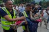 Rescuers carry a victim of flash flooding to safety along the Trishuli River in Nepal's Nuwakot district, Wednesday, Aug. 26, 2026. (AP Photo/Niranjan Shrestha)