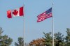 The Canadian and American flags flap in the breeze at the Thousand Islands border crossing in Lansdowne, Ont., on Monday Nov. 8, 2021. THE CANADIAN PRESS/Lars Hagberg