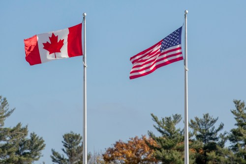The Canadian and American flags flap in the breeze at the Thousand Islands border crossing in Lansdowne, Ont., on Monday Nov. 8, 2021. THE CANADIAN PRESS/Lars Hagberg