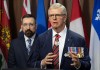 Valour in the Presence of the Enemy founder Bruce Moncur looks on as former chief of defence staff Rick Hillier speaks during a news conference on Parliament Hill in Ottawa on Wednesday, April 15, 2026. THE CANADIAN PRESS/Adrian Wyld