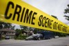 A police officer takes notes outside a home where a woman was injured in a house fire Sunday and later died, during an investigation in Port Moody, B.C., on Monday July 11, 2016. THE CANADIAN PRESS/Darryl Dyck