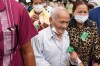 FILE- Bou Meng, center, former S-21 prison survivor, leaves the courtroom after the verdict is announced for Khieu Samphan, former Khmer Rouge head of state, at the U.N.-backed war crimes tribunal in Phnom Penh, Cambodia, Thursday, Sept. 22, 2022. (AP Photo/Heng Sinith, file)
