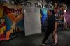 A man walks by a drawing poster promoting a Chinese animated film 