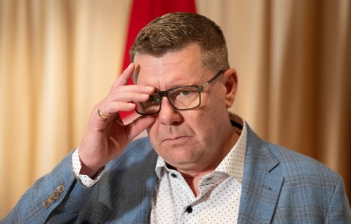 Saskatchewan Premier Scott Moe adjusts his glasses as he speaks with reporters in Mumbai, India, Friday, Feb. 27, 2026. THE CANADIAN PRESS/Adrian Wyld
