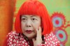 FILE - Japanese avant-garde artist Yayoi Kusama, wearing a bright red wig and a Louis Vuitton polka dot scarf, speaks during an interview at her studio in Tokyo, on Aug. 1, 2012. (AP Photo/Itsuo Inouye, File)