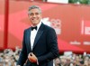 FILE - George Clooney poses on the red carpet at the premiere of his film 