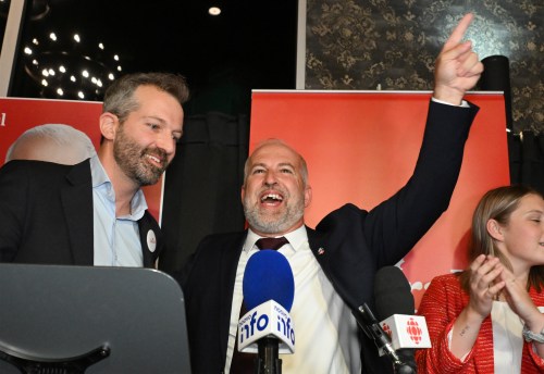 Liberal MP-elect Daniel Gobeil, right, reacts to winning in the byelection in the riding of Chicoutimi-Le Fjord in Saguenay, Monday, Aug. 31, 2026. Minister of Public Works and Procurement Joel Lightbound looks on. THE CANADIAN PRESS/Jacques Boissinot
