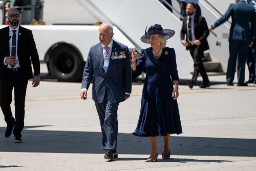 King Charles, left, and Queen Camilla walk on the tarmac of the Ottawa International Airport in Ottawa on Tuesday, May 27, 2025. THE CANADIAN PRESS/Spencer Colby