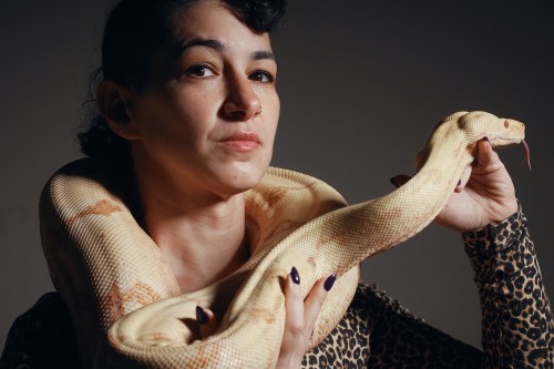 Performance artist Zoe Ziegfeld who plays the part of a snake charmer poses for a portrait with a snake during auditions to select a snake for a part in an adaptation of Mozart’s “Così fan tutte,