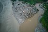 A drone view shows houses damaged by flash floods surrounded by sludge, mud and debris along the swollen Trishuli River in Devighat, Nepal, Thursday, Sept. 3, 2026. (AP Photo/Rajesh Kumar Singh)