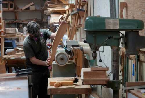 A worker sands the arm of an Adirondack chair at a factory in Kemptville, Ont. approximately 50km south of Ottawa, on Thursday, Sept. 3, 2026.  THE CANADIAN PRESS/Adrian Wyld