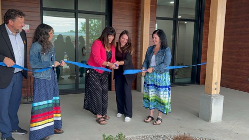 Housing, Addictions and Homelessness Minister Bernadette Smith and John Howard Society of Brandon executive director Michelle Lemoine cut the ribbon during the opening of the society's new 24-unit transitional housing complex on Monday morning, while Municipal and Northern Relations Minister Glen Simard (left), society's care coordinator Janelle Zazalak (second left), and Carla McDonald, who is the director of transitional housing, look on. (Supplied)