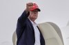 President Donald Trump gestures as he boards Air Force One at Morristown Airport, Sunday, Aug. 16, 2026, in Morristown, N.J. (AP Photo/Julia Demaree Nikhinson)