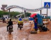 FILE - Motorcyclists ride by the entrance of the airport in Niamey, Niger, Aug. 8, 2023. (AP Photo/Sam Mednick, File)